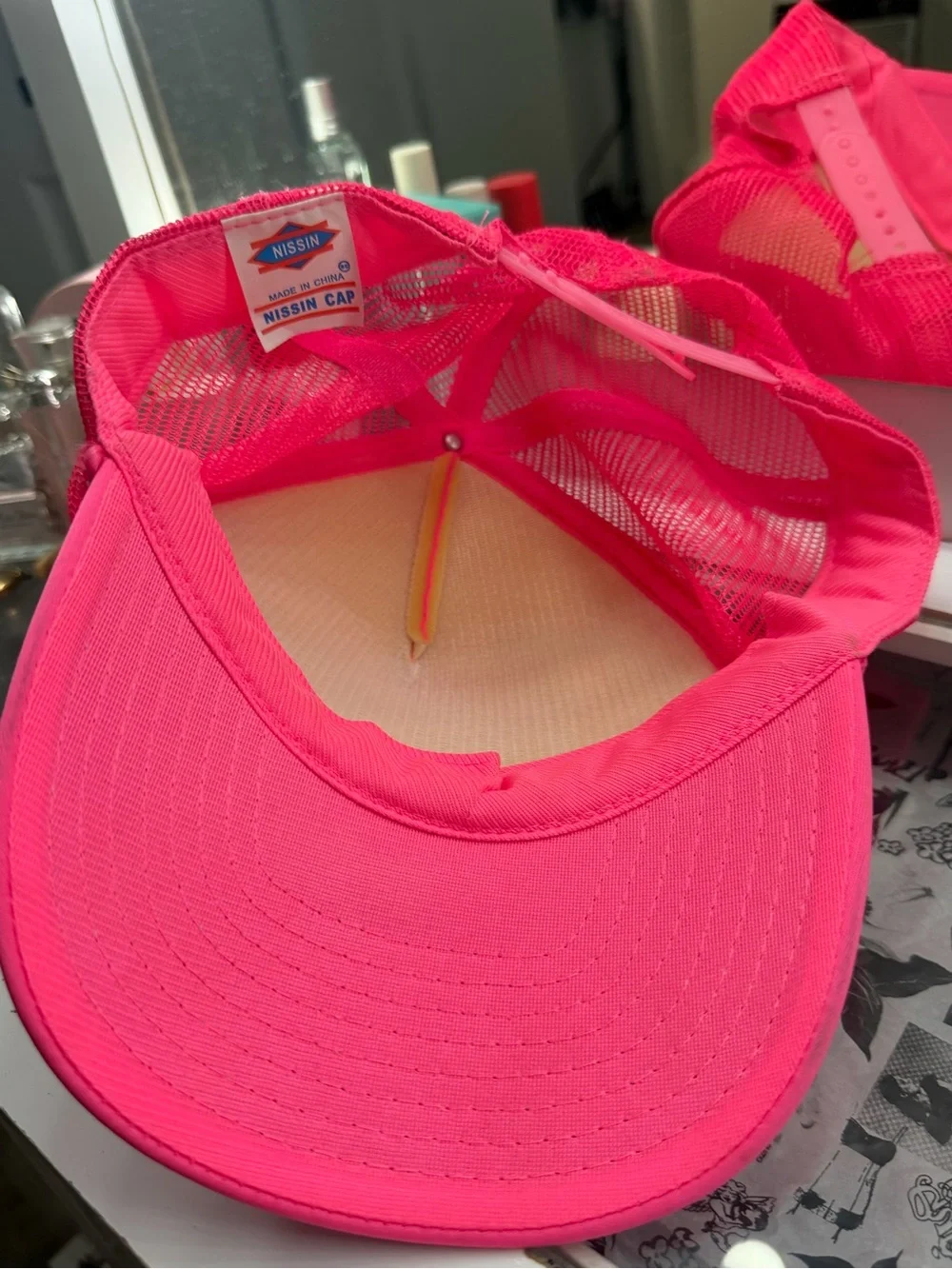 Hot pink trucker hat with “Chloe” in spray paint